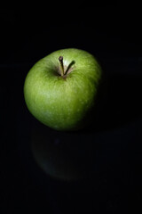 Green Granny smith apple isolated on dark background