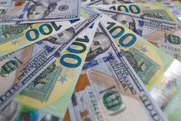 Obraz premium US 100 dollar and 100 euro banknotes background for design purpose