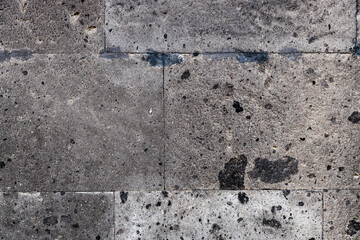 wall of house from natural black tuff stone