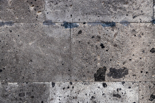 wall of house from natural black tuff stone