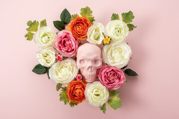 Creative Halloween layout made of pink skull with flowers on pink background. Minimal holiday concept.