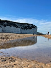 white cliff and water reflection