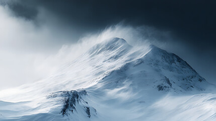 Obraz premium A steep mountain ridge blanketed in fresh snow with icy winds whipping around the summit and dark storm clouds overhead.