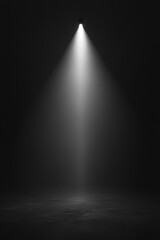 A single spotlight shines in a dark room, creating a dramatic and focused illumination that highlights the texture of the floor