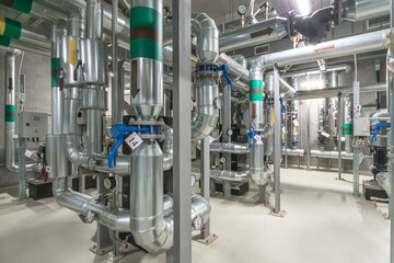 A detailed view of a complex industrial piping system within a commercial building, highlighting...