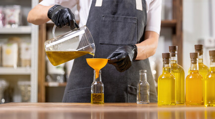Craft fresh oil from hemp cannabis seeds bottling in glasses bottle. Eco food manufacturing