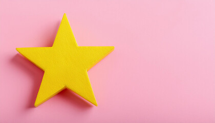 Obraz premium Yellow star isolated on pink backdrop. Banner with copy space.