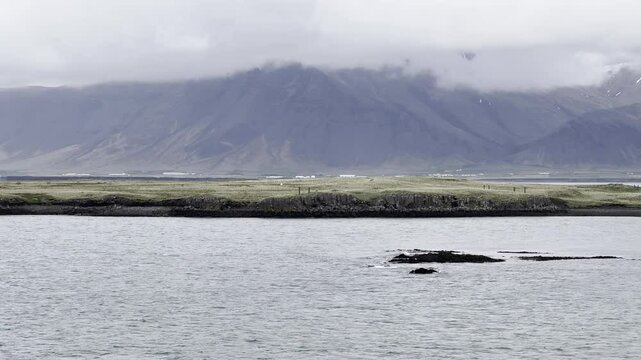 Reykjavik, Iceland - stunning landscape view during a sail away of Vesturey island and Reykjav&iacute;kurborgs shoreline