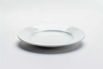 A single white plate sits on top of a table
