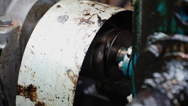 Oil pumping machine working and vibrating pumping oil from tank close up. Oil flows through hose