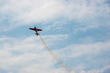A pilot flies an aerobatic propeller plane in the sky