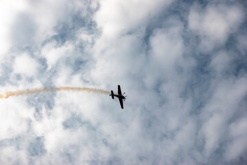 A pilot flies an aerobatic propeller plane in the sky