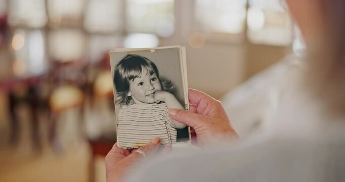 Memory, photo and zoom on hands of senior woman with nostalgia, past or history at home. Closeup, pictures and elderly female person remember with photograph collection in a house, lonely or alone