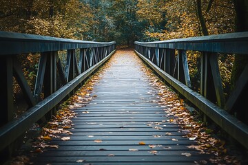 Obraz premium Wooden bridge in the fall with leaves on the ground. Concept of path, journey, change, and transition.