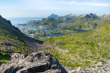 Rocky mountains with lakes and ocean with Svolvayer city view, Floya hiking trail near Djevelporten in Lofoten Norway