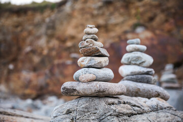 serene beach scene with smooth rocks stacked in a balanced formation. The tranquil atmosphere evokes a sense of zen, harmony, and peace, symbolizing balance and mindfulness in nature
