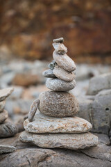 serene beach scene with smooth rocks stacked in a balanced formation. The tranquil atmosphere evokes a sense of zen, harmony, and peace, symbolizing balance and mindfulness in nature