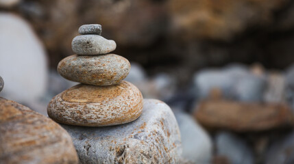 serene beach scene with smooth rocks stacked in a balanced formation. The tranquil atmosphere evokes a sense of zen, harmony, and peace, symbolizing balance and mindfulness in nature