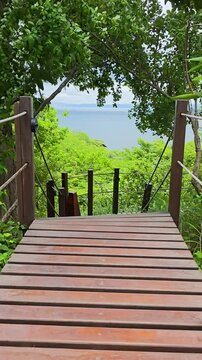 footage of the blue waters of Culebra Bay with lush green trees, plants and grass, blue sky and clouds in Liberia Guanacaste Costa Rica