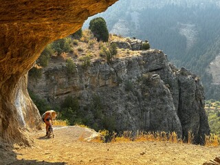 senior woman hiker and dog hiking in wind caves Logan Canyon Utah
