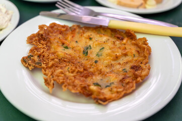 Traditional Andalusian dish from potato and seafood, Tortillitas de Camarones, Shrimp Fritters served in old tavern as tapas, Sanlucar de Barrameda, Spain