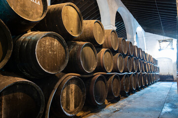 Solera system in old Andalusian wine cellar, process for aging sherry wine in barrels, fino, manzanilla, olorosso, amontillado jerez fortified wine, Sanlucar de Barrameda, Cadiz, Andalusia, Spain
