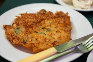 Traditional Andalusian dish from potato and seafood, Tortillitas de Camarones, Shrimp Fritters served in old tavern as tapas, Sanlucar de Barrameda, Spain