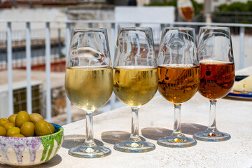 Sherry wine tasting on roof of old Triana district in Sevilla with view on Sevilla houses and churches, wine glasses