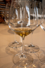 Tasting of sweet Bordeaux white wine in Sauternes, left bank of Gironde Estuary, France. Glasses of white sweet French wine served in restaurant