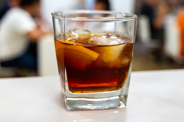 Tasting Sherry sweat cream wine on ice rocks, jerez fortified wine made from palomino white grape served in Jerez de la Frontera, Cadiz, Andalusia, Spain