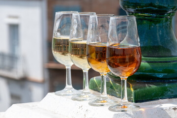 Sherry wine tasting on roof of old Triana district in Sevilla with view on Sevilla houses and churches, wine glasses