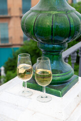 Sherry fino wine tasting on roof of old Triana district in Sevilla with view on Sevilla houses and churches, wine glasses