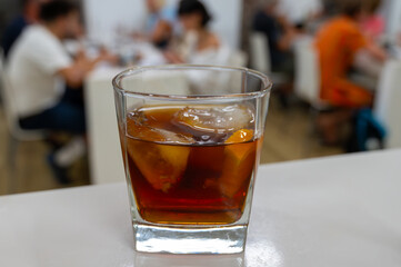 Tasting Sherry sweat cream wine on ice rocks, jerez fortified wine made from palomino white grape served in Jerez de la Frontera, Cadiz, Andalusia, Spain