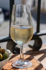 Sherry fino or manzanilla wine, jerez fortified wine made from palomino white grape served with green olives in Jerez de la Frontera, Cadiz, Andalusia, Spain