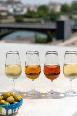 Sherry fino, manzanilla, cream wine tasting on roof of old Triana district in Sevilla with view on Sevilla houses and churches, wine glasses