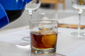 Tasting Sherry sweat cream wine on ice rocks, jerez fortified wine made from palomino white grape served in Jerez de la Frontera, Cadiz, Andalusia, Spain