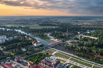 Summer aerial skyline landscape of Głogów, Lower Silesia (Dolny Śląsk). Wide panoramic view at Bulwar Nadodrzański and Most Tolerancji bridge at sunset