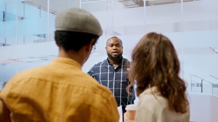 Real estate advisor discussing a promising property deal with potential corporate clients, examining blueprints and planning architectural layout of modern office space. Consider renting. Camera A.