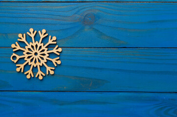 Beautiful snowflake on wooden background, top view