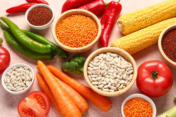 Different fresh vegetables and cereals on pink background, closeup
