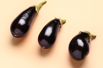 Fresh eggplants on beige background