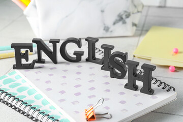 Word ENGLISH and stationery on white table