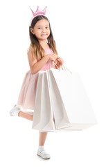 Cute little girl with shopping bags isolated on white