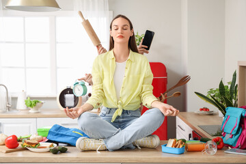 Young woman with a lot of things to do meditating in kitchen