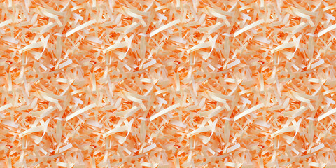 Fototapeta premium shredded paper filler in apricot color with thin, delicate strips, shredded paper filler texture background