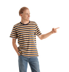 Naklejka premium Handsome young man in striped t-shirt pointing at something on white background
