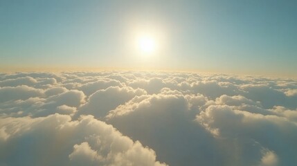 Beautiful aerial view of dense clouds from an airplane, with a clear sky above and the sun casting golden light on the cloud tops