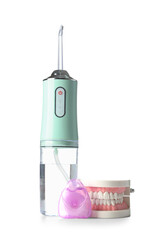 Oral irrigator,dental floss and jaw model on white background