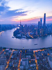 Aerial view of modern city skyline and buildings at sunrise in Shanghai