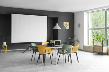 Interior of conference room with table and projector screen